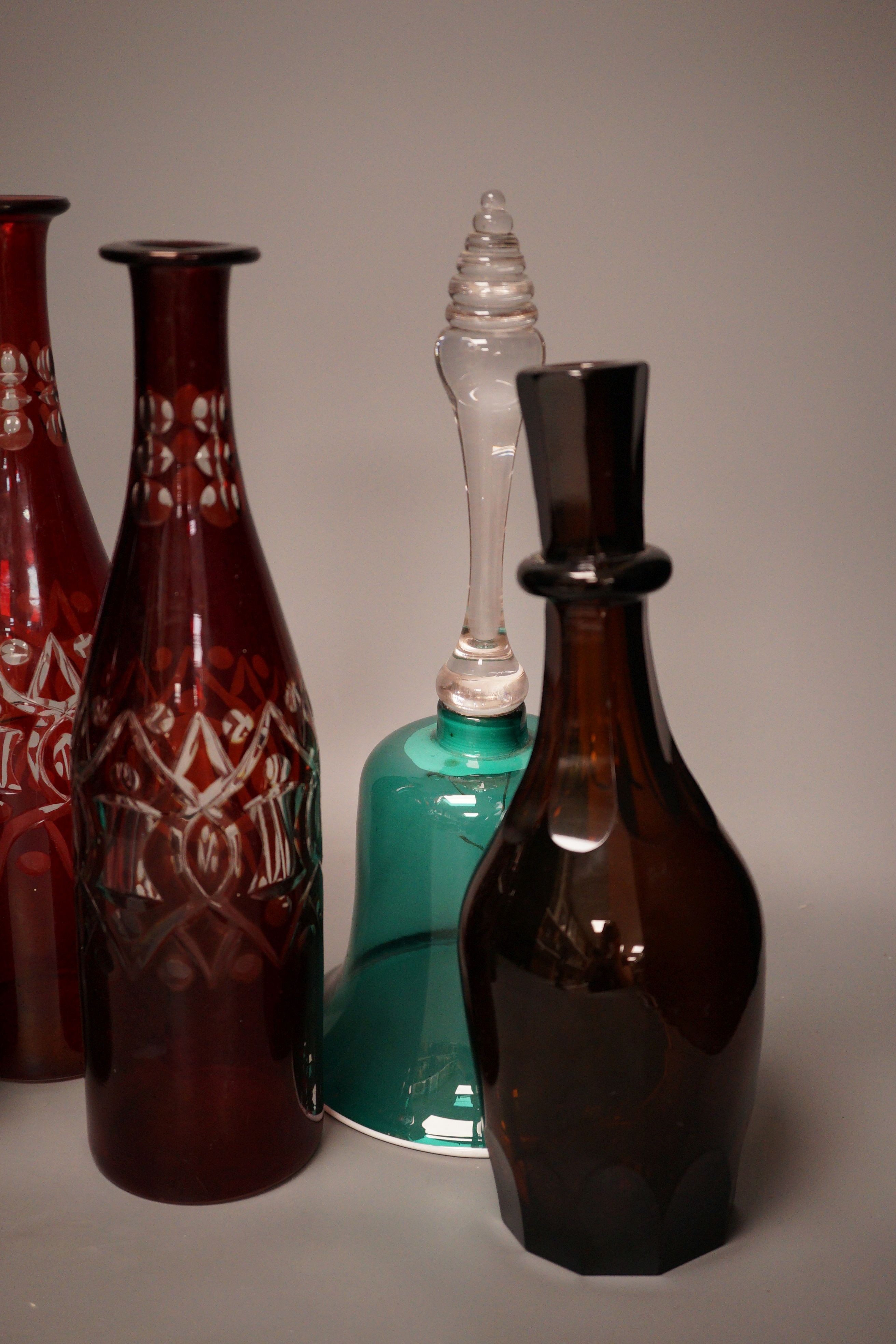 A pair of cut ruby flashed glass decanters, late Georgian emerald green glass decanter, and four other items